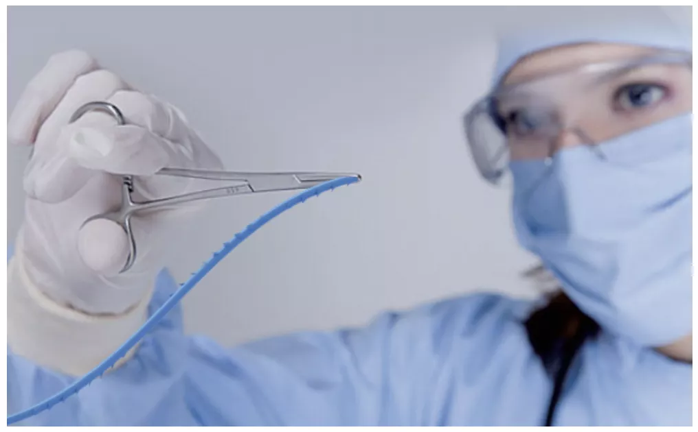 Absorbable barbed suture